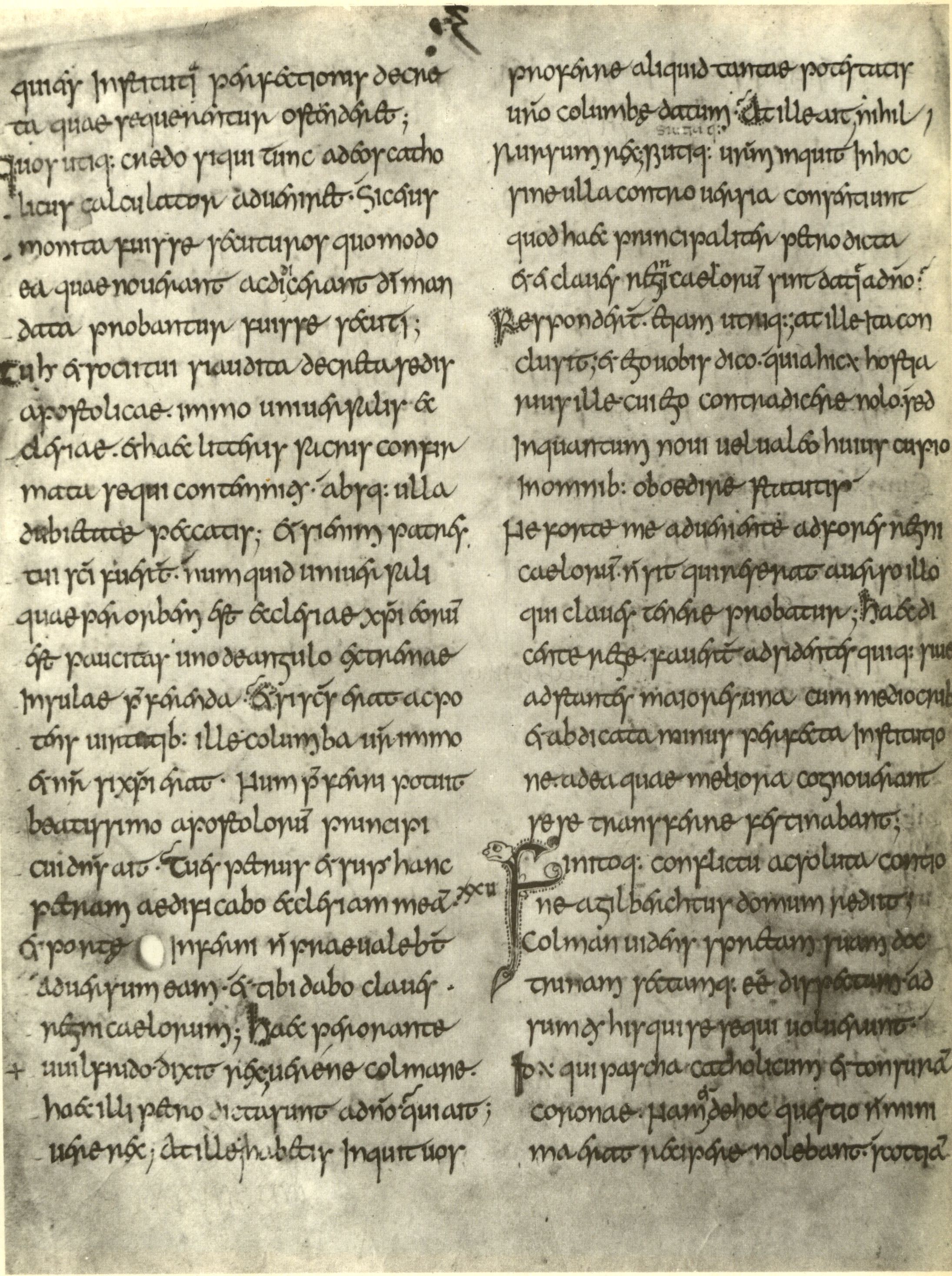 A manuscript folio in an early insular hand: long lines of Latin in brown ink on vellum, ruled, with enlarged initials and some staining along one edge.